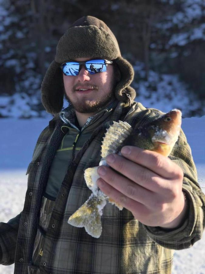 Man holding up a fish in winter clothes